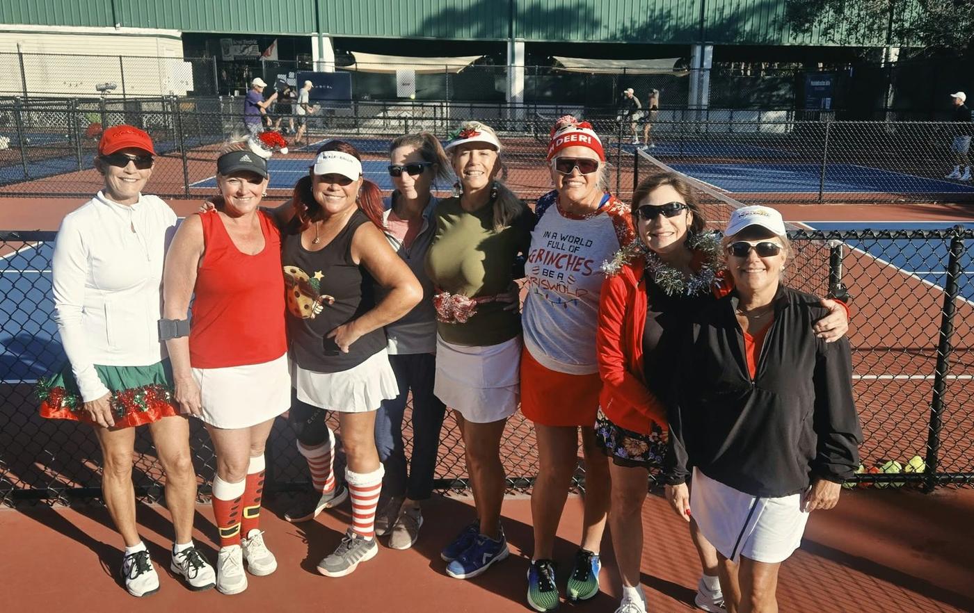 Jill Jacobs and friends in festive outfits for a holiday pickleball game