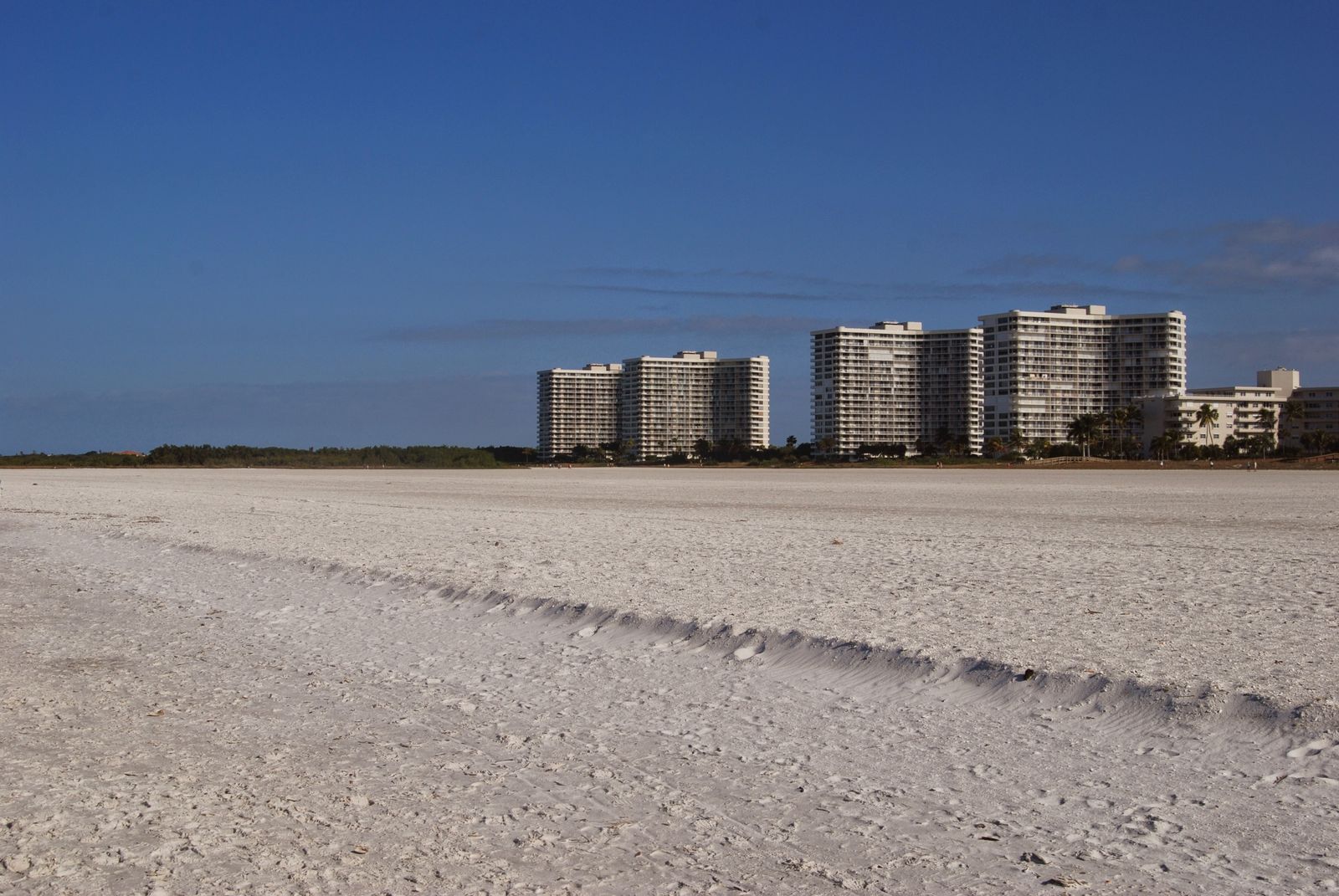 Wide white-sand beach and high-rises on Marco Island, Florida